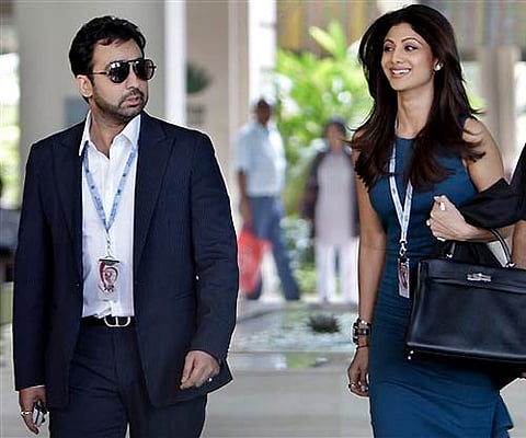 Bollywood actress and co-owner Rajasthan Royals team Shilpa Shetty, right, arrives with her husband Raj Kundra for the IPL player auction in Bangalore. AP