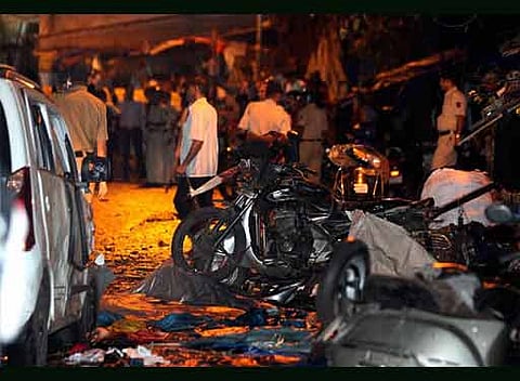 Mumbai People at the site of a blast at Prasad Chambers in Opera House in Mumbai on Wednesday.Police inspect the site of an explosion at Dadar in Mumbai. AP