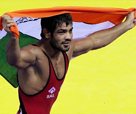 Sushil Kumar celebrates after winning the the 66-kg category free-style wrestling event. AP