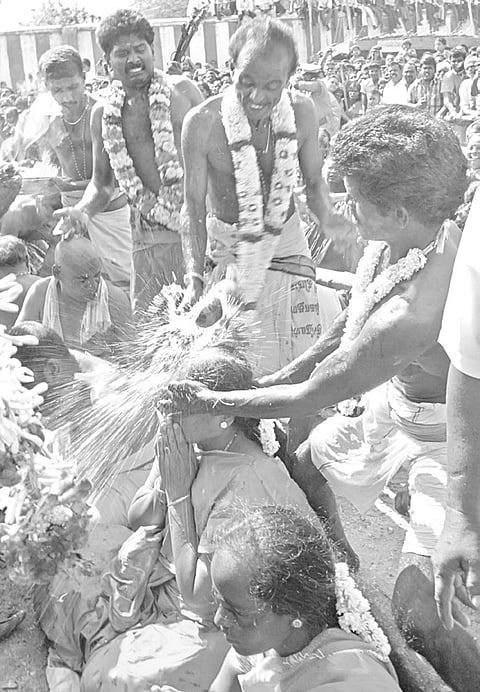 525 break coconuts on heads at Karur temple
