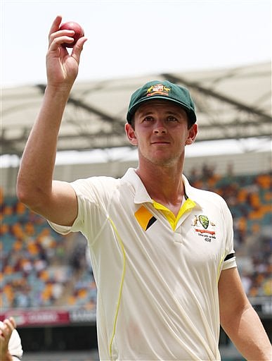 Australian bowler Josh Hazlewood holds the ball aloft after taking five wickets on debut during play on day two of the second cricket Test against India in Brisbane, Australia, Thursday. AP