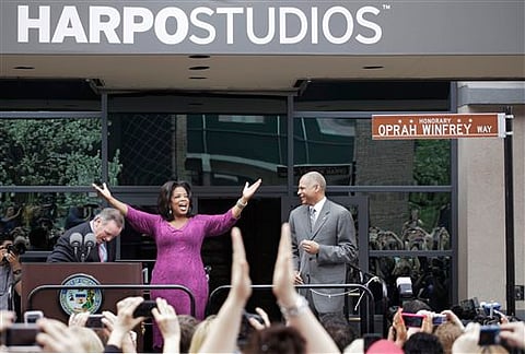Oprah Winfrey reacting after a street outside her Harpo Studios in Chicago was proclaimed "Oprah Winfrey Way" during a ceremony with Chicago Mayor Richard M. Daley (eft) and Bobby Ware, commissioner of the Chicago Department of Transportation. | AP file
