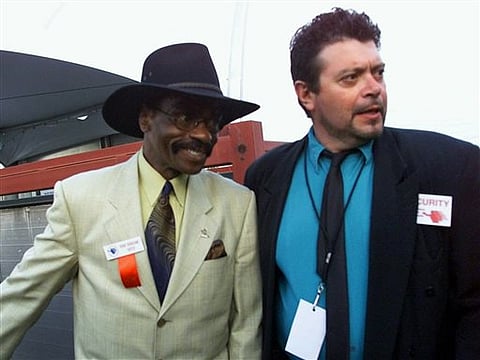 Former middleweight boxer Rubin "Hurricane" Carter, left, is escorted by an unidentified security guard into the venue where Laila Ali and Jacqui Frazier-Lyde will box each other in Verona, NY. | AP Photo/Beth A. Keiser, File