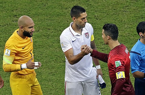 Portugal's Cristiano Ronaldo, right, shakes hands with United States' Clint Dempsey and goalkeeper Tim Howard, far left, prior to the group G World Cup soccer match between the USA and Portugal at the Arena da Amazonia in Manaus, Brazil, Sunday, June 22