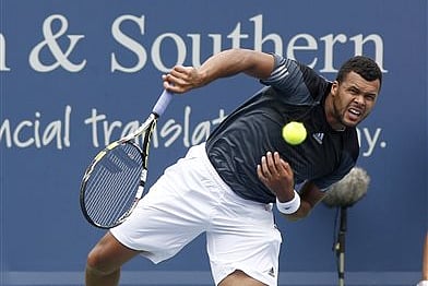 Jo-Wilfred Tsonga, from France, serves to Mikhail Youzhny, from Russia, during a first round match at the Western & Southern Open tennis tournament, Tuesday, Aug. 12, 2014, in Mason, Ohio. (AP Photo/David Kohl)