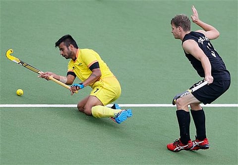 Manpreet Singh of India, left, vies for the ball with Steve Edwards of New Zealand in their men's semifinal hockey match during the Commonwealth Games 2014 in Glasgow, Scotland, Saturday | AP