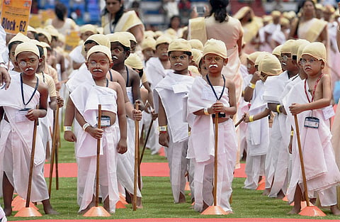 Students of Venkat International School attempt to make the world record for the largest gathering of people dressed as Mahatama Gandhi on the occasion of Gandhi Jayanti at Kanteerava stadium in Bengaluru on Friday. 4605 students together took part in the