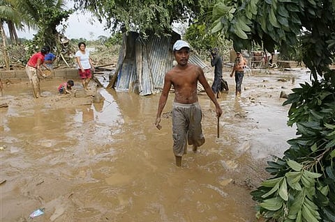 Residents begin cleaning up their homes Tuesday, Oct. 20, 2015, two days after Typhoon Koppu battered northern Philippines and flooded Cabanatuan city and nearby provinces | AP
