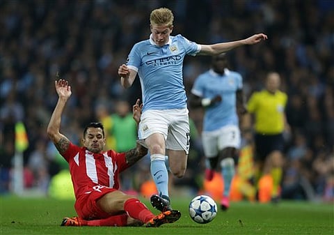 Sevilla's Vitolo, left, tackles Manchester City's Kevin De Bruyne for the ball during the Champions League Group D soccer match between Manchester City and Sevilla at the Etihad Stadium, Manchester, England,. | AP 