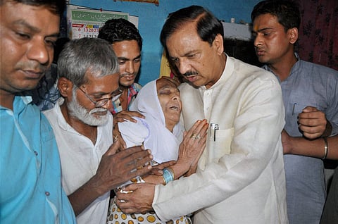  Tourism Minister Mahesh Sharma meeting the family of Ikhlaq who was beaten to death by a mob at Bisara in Dadri on October 2. | PTI