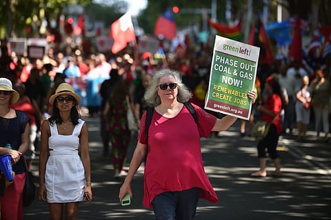 A participant holds up a sign during a rally calling for action on climate change in Sydney. 