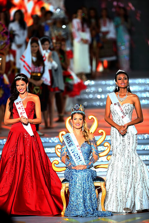 Miss World Mireia Lalaguna Royo from Spain, centre, Sofia Nikitchuk from Russia, left, the runner-up, and Maria Harfanti from Indonesia, right, the second runner-up celebrate at the end of the 2015 Miss World Grand Final in Sanya in south China's Hainan 