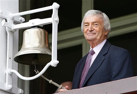 FILE - In this Friday, July 17, 2009 file photo former Australian cricketer Richie Benaud rings the bell on the pavillion balcony on the second day of the second cricket test match between England and Australia at Lord's cricket ground in London. Former 