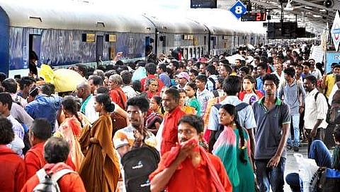 Passenger jostle with each other to get on board a train at Visakhapatnam railway station on Sunday | Express