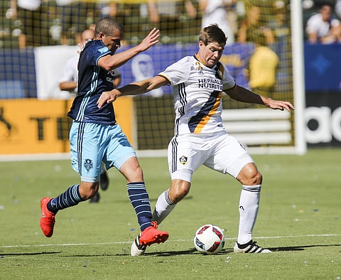 Seattle Sounders midfielder Osvaldo Alonso, left, and Los Angeles Galaxy midfielder Steven Gerrard, battle for the ball in the second half of an MLS soccer game in Carson. | AP