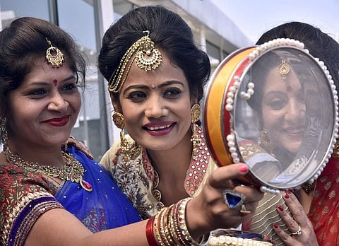 Women dress up in pretty sarees and jewellery as they take part in pre-Karva Chauth celebrations at Banjara Hills in Hyderabad. (Vinay Madapu | EPS)