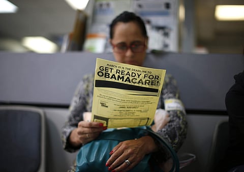 A woman reads a leaflet on Obamacare. (File Photo | Reuters)