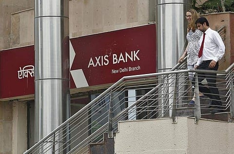 People use a staircase next to a corporate branch office of Axis Bank in New Delhi July 18, 2013. | Reuters