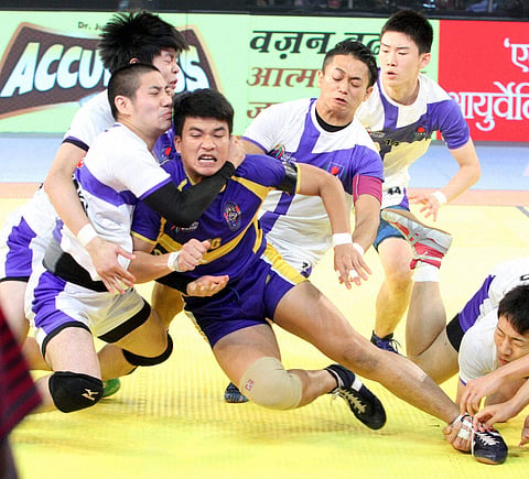 Japanese kabaddi team player try to catch Thailand's blue player during 'Kabaddi World Cup 2016' match in Ahmedabad. (PTI)