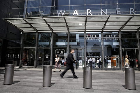 FILE - In this Tuesday, May 26, 2015 file photo, pedestrians walk by an entrance to the Time Warner Center in New York. | AP