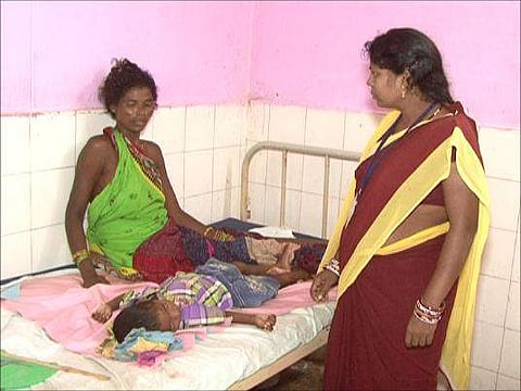 A child receives treatment for Japanese encephalitis at the district headquarters hospital in Malkangiri, Odisha.  | EPS