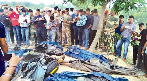 Police and scribes take photos of the bodies of slain Maoists wrapped in sheets at Malkangiri in Odisha on Monday | Express photo
