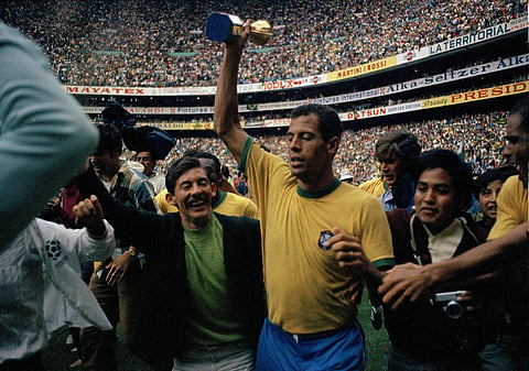 In this June 21, 1970 file photo, Brazil's team captain Carlos Alberto, center, holds up the golden Jules Rimet Trophy. | AP
