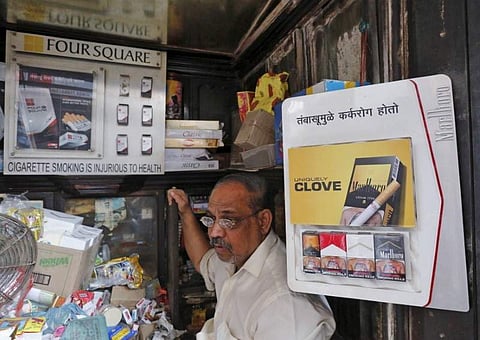 A shopkeeper selling cigarettes in Mumbai. (File photo | Reuters)