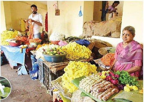 Flower vendors wait for customers in Udupi taluk, Karnataka