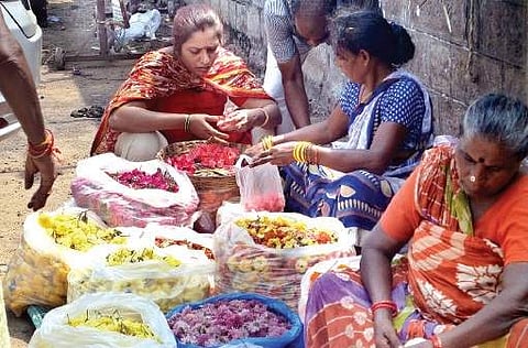 Vendors sorting out flowers near Poorna Market in Vizag on Saturday  | Express