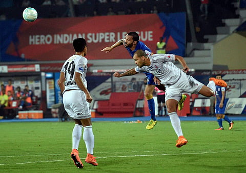 Players of Mumbai City FC in blue jersey and FC Pune City in white jersey clash during their ISL Match in Mumbai on Thursday. |PTI