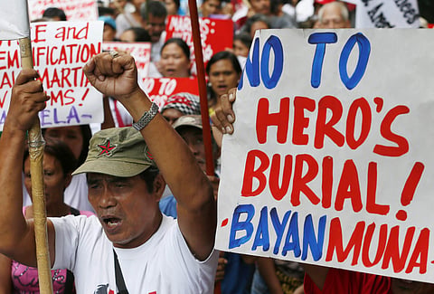 Protesters shout slogans as they await the ruling of the Philippine Supreme Court on whether to allow or not the burial of the late Philippine dictator Ferdinand Marcos at the Heroes' Cemetery. | AP