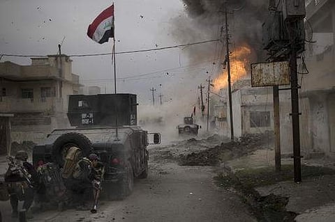 A car bomb explodes next to Iraqi special forces armored vehicles as they advance towards Islamic State held territory in Mosul.(Photo | AP)