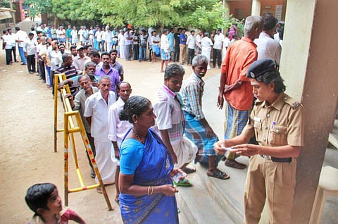The people are seen waiting in a long queue to cast their votes for Thiruparankundram by-election in a polling booth at Iravathanallur in Madurai on Saturday .(K K Sundar | EPS)