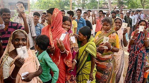 A file photo of people standing in queue to cast their votes. (File Photo | PTI)