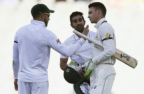 South Africa's Faf du Plessis, left, along with teammate Tabraiz Shamsi congratulate Australia's Peter Handscomb, right, at the end of their cricket test match in Adelaide, Australia. | AP