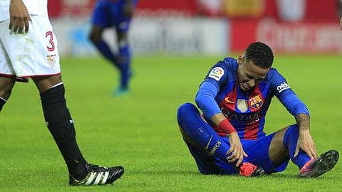 Barcelona's Neymar sits on the pitch at the Sanchez Pizjuan stadium in Spain. (File photo | AP)