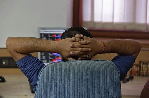 A broker reacts while trading at his computer terminal at a stock brokerage firm in Mumbai. (File photo | Reuters)
