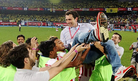 Atletico de Kolkata players celebrate with coach after winning the final of the Indian Super League ISL season 3 at the Jawaharlal Nehru Stadium in Kochi on Sunday | PTI