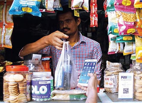 A shopkeeper accepting payment through the mobile wallet app in  Hyderabad on Sunday | Sathya Keerthi