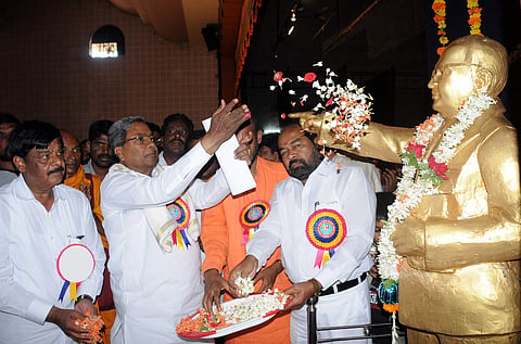 Chief minister Siddaramaiah showering petals on Dr BR Ambedkar’s statue in Mysuru on Saturday | Express