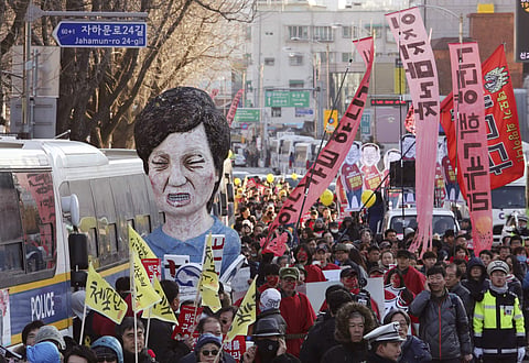 Protesters carry an effigy of impeached South Korean President Park Geun-hye. (Photo | AP)