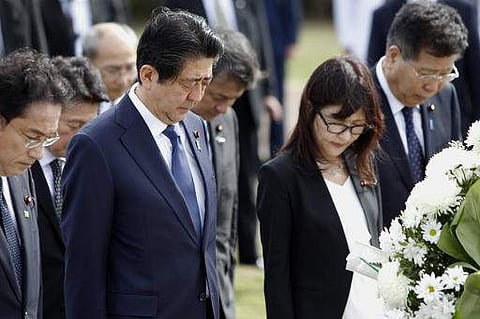 Japanese Defense Minister Tomomi Inada, second from right, and Japanese Prime Minister Shinzo Abe, second from left, bow at the Ehime Maru Memorial in Honolulu on December 26. (Photo | AP)