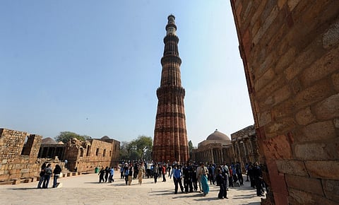 School children and tourists visit the historic landmark Qutub Minar in New Delhi | AFP