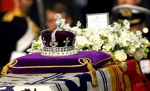 FILE- in this April 5 2002 file photo The Koh-i-noor or "mountain of light " diamond set in the Maltese Cross at the front of the crown made for Britain's late Queen Mother Elizabeth is seen on her coffin along with her personal standard a wreath and a