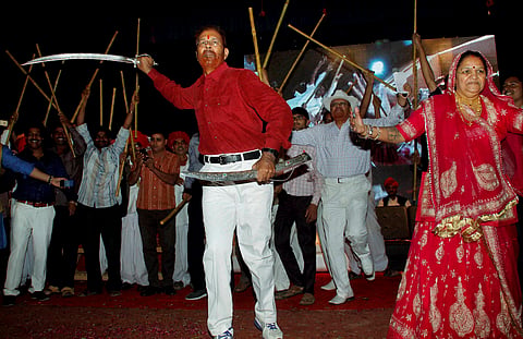 Retired IPS officer D G Vanzara dances with a sword during a welcome ceremony by his community in Gandhinagar on Friday. | PTI