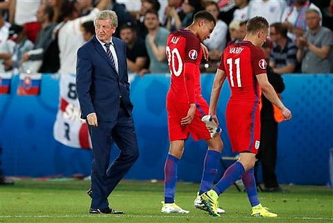 England coach Roy Hodgson, Dele Alli and Jamie Vardy, from left to right, leave the pitch at the end of the match against Slovakia. | AP