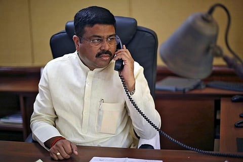 India's Oil Minister Dharmendra Pradhan speaks on phone during an interview with Reuters in New Delhi, India, May 5, 2016. | Reuters