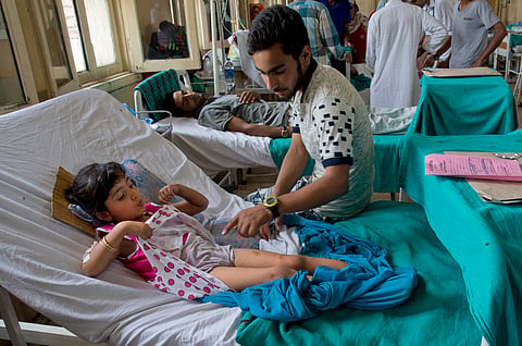 An unidentified relative of 5 years old girl Zohra Zahoor, shows her injuries as she rests on a hospital bed in Srinagar, Indian controlled Kashmir, Wednesday, July 13, 2016 | AP