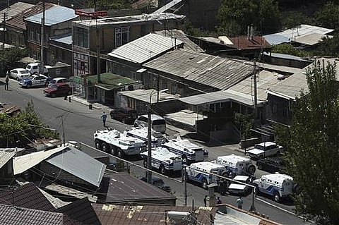 Armenian police and special forces block a street leading to the area where a group of armed men has attacked a central police station. | AP